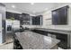 Modern kitchen with stainless steel appliances, dark cabinets, and a large island at 2559 Eagle Bay Blvd, Kissimmee, FL 34743
