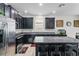Modern kitchen with stainless steel appliances, dark cabinets, and granite countertops at 2559 Eagle Bay Blvd, Kissimmee, FL 34743