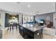 Open kitchen with granite island, dark cabinets, and connected living space at 2559 Eagle Bay Blvd, Kissimmee, FL 34743