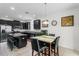 Modern kitchen with dark cabinetry, stainless steel appliances, and dining area at 2559 Eagle Bay Blvd, Kissimmee, FL 34743