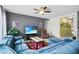 Bright living room featuring a comfortable blue sectional and neutral carpet at 2559 Eagle Bay Blvd, Kissimmee, FL 34743