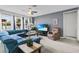 Comfortable living room with a plush blue sectional, recliner and large windows at 2559 Eagle Bay Blvd, Kissimmee, FL 34743
