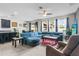 Spacious living room with blue sectional seating, ceiling fan and natural light at 2559 Eagle Bay Blvd, Kissimmee, FL 34743