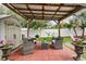 Cozy covered patio area with outdoor seating, storage shed, and barbecue at 2559 Eagle Bay Blvd, Kissimmee, FL 34743