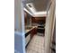 Galley kitchen offers wooden cabinetry, light countertops, and modern black appliances at 2900 S Semoran Blvd # S, Orlando, FL 32822