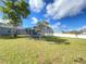 Backyard featuring a lush lawn and screened-in pool at 305 S Palm Ave, Kissimmee, FL 34741