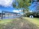 Spacious backyard featuring a screened-in pool and additional storage shed at 305 S Palm Ave, Kissimmee, FL 34741