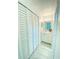 Hall bathroom features a white vanity and a closet for ample storage at 305 S Palm Ave, Kissimmee, FL 34741