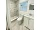 Updated bathroom with modern vanity, walk-in shower with glass door, and neutral tile at 305 S Palm Ave, Kissimmee, FL 34741