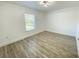 Bright bedroom features wood-look flooring and a modern ceiling light fixture at 305 S Palm Ave, Kissimmee, FL 34741