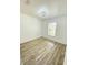 Bright bedroom features wood-look flooring and a modern ceiling light fixture at 305 S Palm Ave, Kissimmee, FL 34741