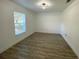 Bright bedroom features wood-look flooring and a modern ceiling light fixture at 305 S Palm Ave, Kissimmee, FL 34741