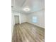 Bright bedroom with modern lighting, neutral walls, and light wood laminate flooring at 305 S Palm Ave, Kissimmee, FL 34741