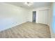 Bedroom features wood-look flooring, a modern ceiling light, and a closet at 305 S Palm Ave, Kissimmee, FL 34741