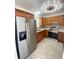 Updated kitchen with stainless steel fridge and modern lighting fixture at 305 S Palm Ave, Kissimmee, FL 34741