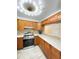 Well-lit kitchen features a modern range, ample countertop space, and rich wood cabinetry at 305 S Palm Ave, Kissimmee, FL 34741