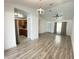 Open-concept living room boasting modern lighting, a ceiling fan, and beautiful wood-look flooring at 305 S Palm Ave, Kissimmee, FL 34741
