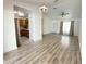 Open-concept living room boasting modern lighting, a ceiling fan, and beautiful wood-look flooring at 305 S Palm Ave, Kissimmee, FL 34741