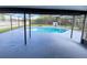 Relaxing screened-in pool area with a view of the fenced yard at 305 S Palm Ave, Kissimmee, FL 34741