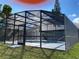 Large screened-in pool enclosure, perfect for outdoor relaxation at 305 S Palm Ave, Kissimmee, FL 34741