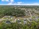 A beautiful aerial view of a sprawling community surrounded by lush greenery and clear blue skies at 33 Perch Dr, Kissimmee, FL 34759