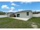 A spacious backyard with a concrete patio, privacy fence and manicured grass at 33 Perch Dr, Kissimmee, FL 34759