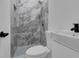 Modern bathroom with a tiled shower, brushed-black fixtures, and a sleek, white sink at 33 Perch Dr, Kissimmee, FL 34759