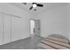 A light-filled bedroom with a ceiling fan, a single bed, and a spacious closet at 33 Perch Dr, Kissimmee, FL 34759