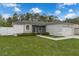 Charming single-story home with a well-manicured lawn, neutral paint, and screened entry at 33 Perch Dr, Kissimmee, FL 34759