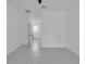 Hallway features neutral tile flooring and a window allowing for plenty of natural light at 33 Perch Dr, Kissimmee, FL 34759