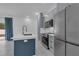 Well-appointed kitchen featuring stainless appliances, custom shaker cabinets, a center island with quartz countertops at 33 Perch Dr, Kissimmee, FL 34759