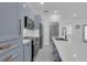 Stylish kitchen with modern appliances, shaker cabinets and a center island featuring a sink and quartz countertop at 33 Perch Dr, Kissimmee, FL 34759