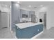 Modern kitchen featuring shaker cabinets, a kitchen island with quartz countertops and tiled floors at 33 Perch Dr, Kissimmee, FL 34759