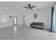 Bright living room featuring tile floors, large windows, and simple decor at 33 Perch Dr, Kissimmee, FL 34759