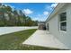 Concrete patio area in a large, grass backyard with a white vinyl privacy fence at 33 Perch Dr, Kissimmee, FL 34759