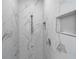 Luxurious marble tiled walk-in shower featuring a rain shower head and built-in shelving at 33 Perch Dr, Kissimmee, FL 34759