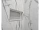 Close-up of a shower niche with penny tile and grey-veined marble tiling at 33 Perch Dr, Kissimmee, FL 34759