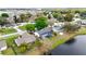 Aerial view of a lakeside house featuring a screened-in pool and verdant surroundings in a quiet neighborhood at 3619 Willow Lake Ct, St Cloud, FL 34769