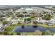 Neighborhood aerial view showcases homes surrounding a serene lake, some with private pools at 3619 Willow Lake Ct, St Cloud, FL 34769