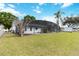 An expansive backyard, screened pool, and a shed, all enclosed by a chain-link fence at 3619 Willow Lake Ct, St Cloud, FL 34769