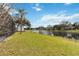 Spacious backyard with pool area overlooking a serene lake, surrounded by lush greenery at 3619 Willow Lake Ct, St Cloud, FL 34769
