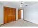 Bright bedroom features a ceiling fan, neutral carpet, and wood closet doors at 3619 Willow Lake Ct, St Cloud, FL 34769