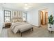 Tastefully staged bedroom with neutral tones, artwork, and a view to ensuite bathroom at 3619 Willow Lake Ct, St Cloud, FL 34769