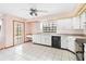 Bright kitchen with white cabinetry, black appliances, and adjacent outdoor access at 3619 Willow Lake Ct, St Cloud, FL 34769