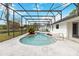 Backyard pool features a screened enclosure, and concrete patio space at 3619 Willow Lake Ct, St Cloud, FL 34769