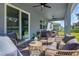 Covered back patio with comfortable seating and views of the landscaped yard at 3987 Meandering Bay Dr, Apopka, FL 32712