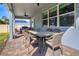 Covered back patio with outdoor dining and seating at 3987 Meandering Bay Dr, Apopka, FL 32712