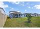 Large backyard features a covered patio, perfect for entertaining, and a well-maintained lawn at 3987 Meandering Bay Dr, Apopka, FL 32712