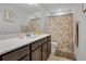 Bathroom featuring a modern vanity, toilet, and shower with earth-toned floral pattern curtain at 3987 Meandering Bay Dr, Apopka, FL 32712