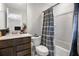 Bathroom featuring a modern vanity, toilet, and shower with elegant gray patterned curtain at 3987 Meandering Bay Dr, Apopka, FL 32712